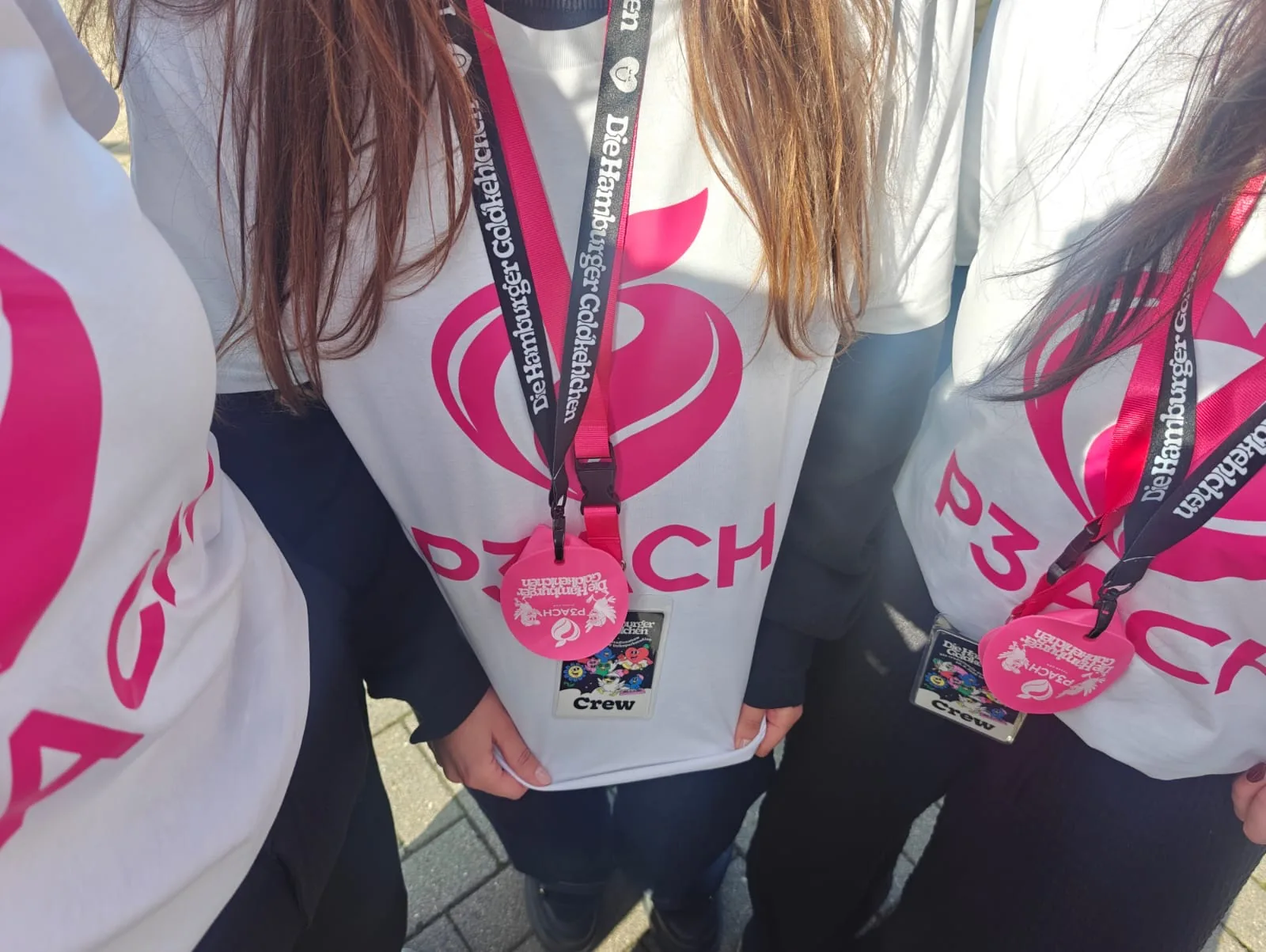 P3ACH crew in branded shirts with crew passes and edition covers on their lanyards