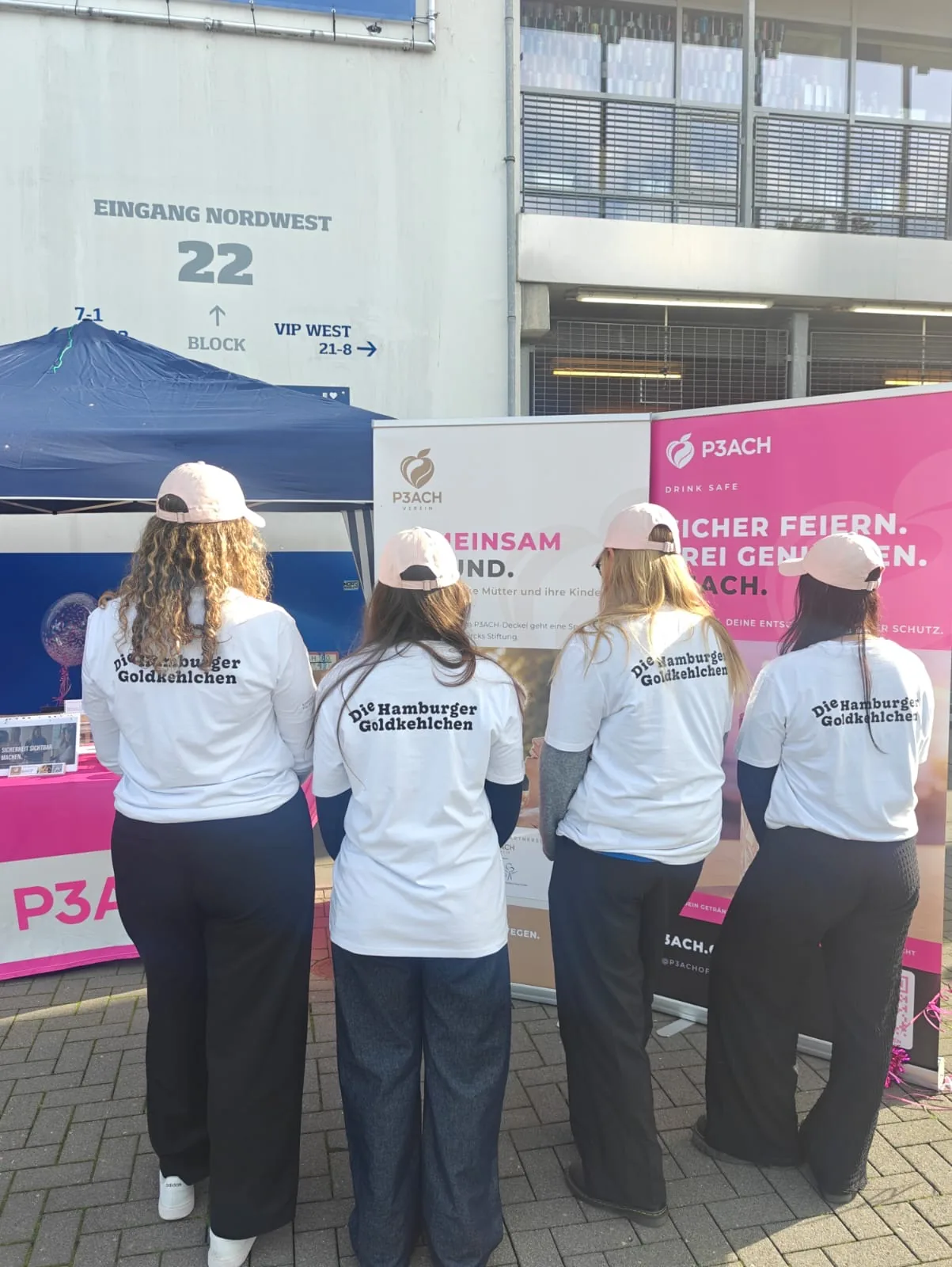 P3ACH crew in Goldkehlchen shirts and P3ACH caps at the Volksparkstadion entrance, next to the P3ACH roll-ups
